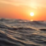 Captivating ocean waves with a vibrant sunset sky, perfect for tranquil moments.